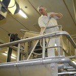 Oompa Loompa feeding a machine with raw ingredients